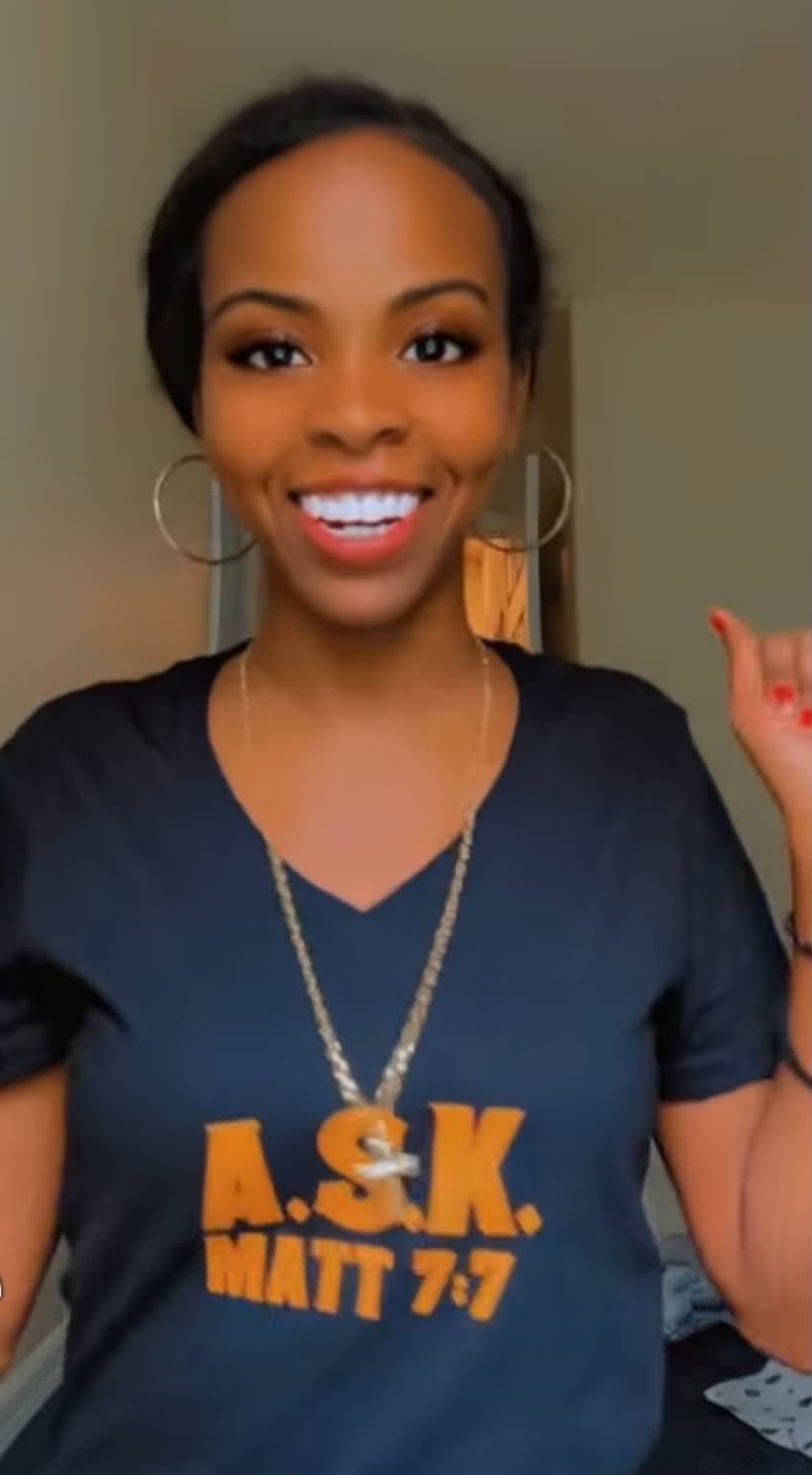 Smiling customer wearing the navy A.S.K. Matt 7:7 tee