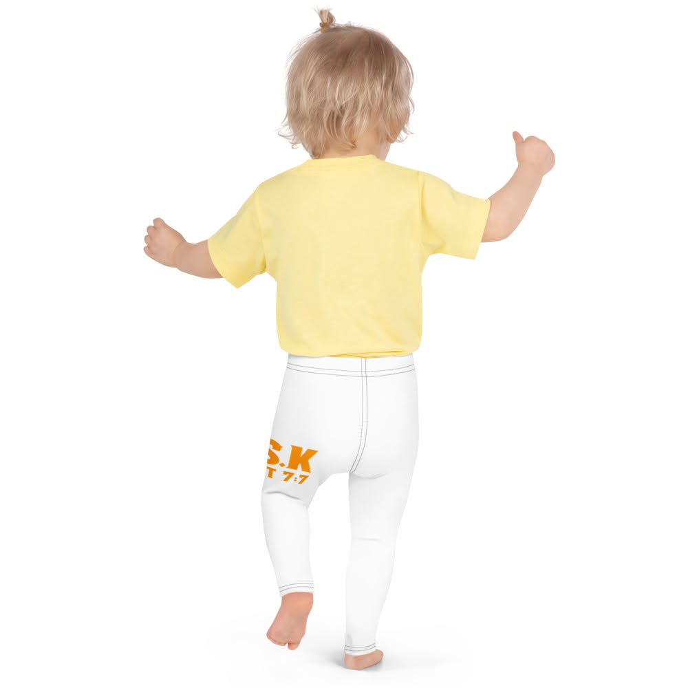 Toddler from behind in a yellow tee and white A.S.K. leggings