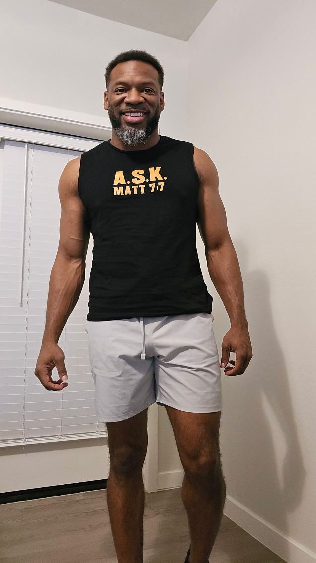Man smiling in a black A.S.K. tank with Matt 7:7